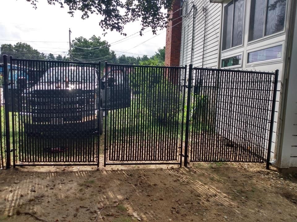 Black chain link fence securing a rear yard