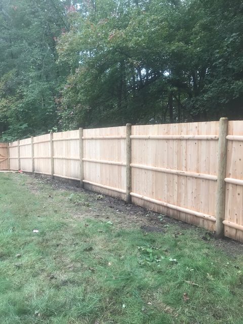 Cedar board privacy fence along a narrow side yard