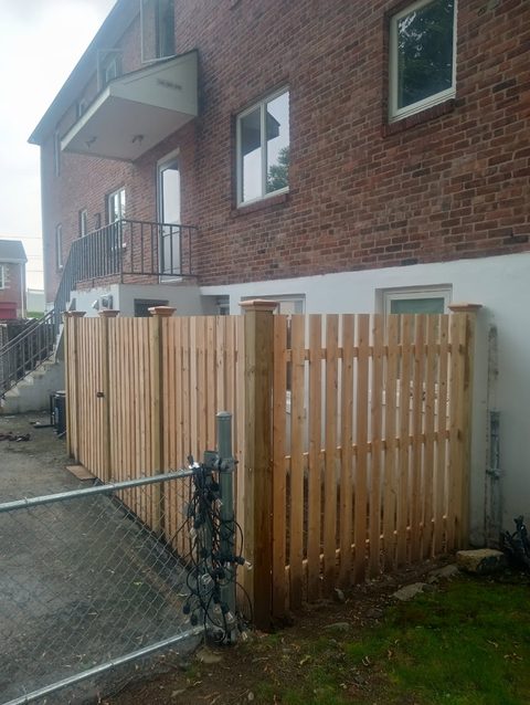 Cedar gate and matching fence giving side access to a yard