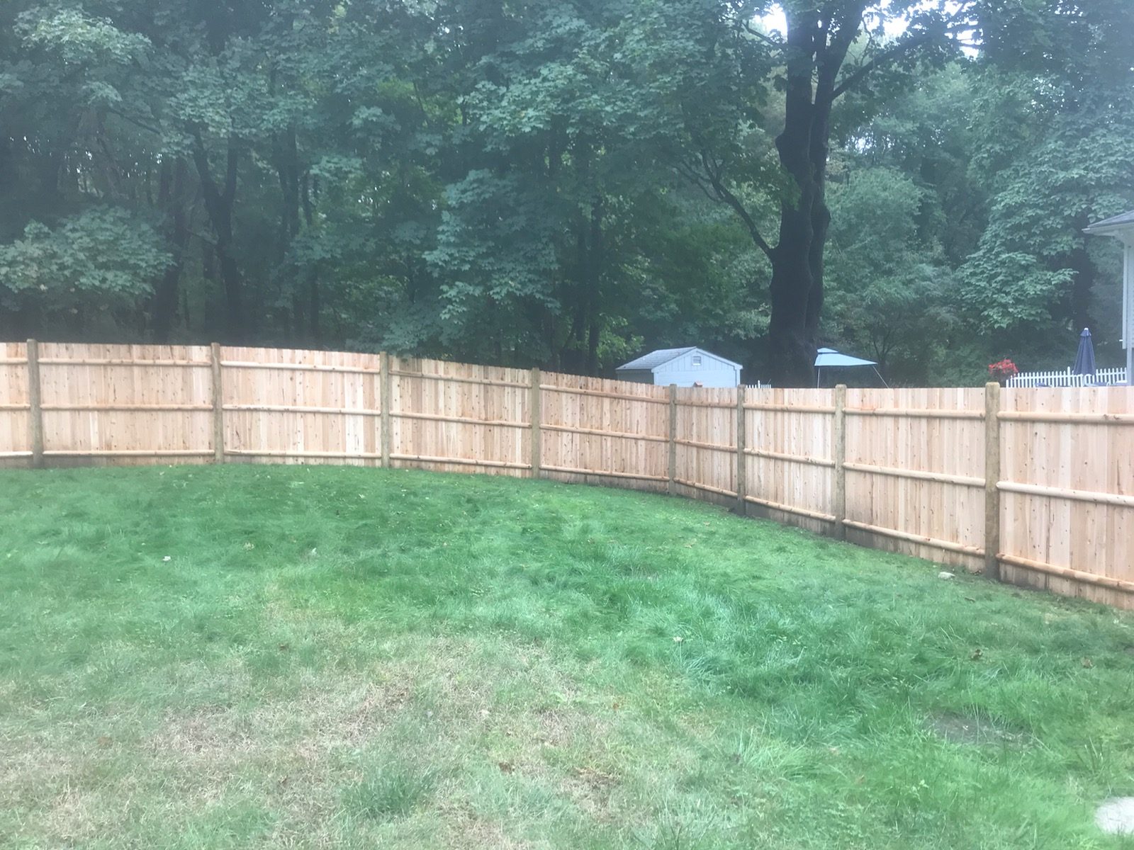 Cedar privacy fence following a curved rear boundary line