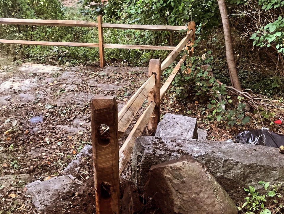 New fence post being set during a post replacement repair