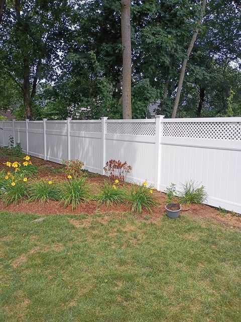 Vinyl fence behind a planted garden border