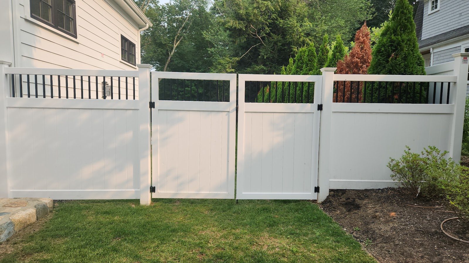 Vinyl fence panel with lattice detail and a closed walk gate