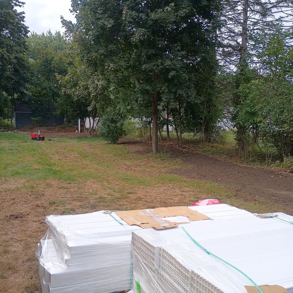 Vinyl fence panels stacked on site ready for installation