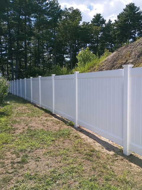 White vinyl privacy fence forming a long rear boundary